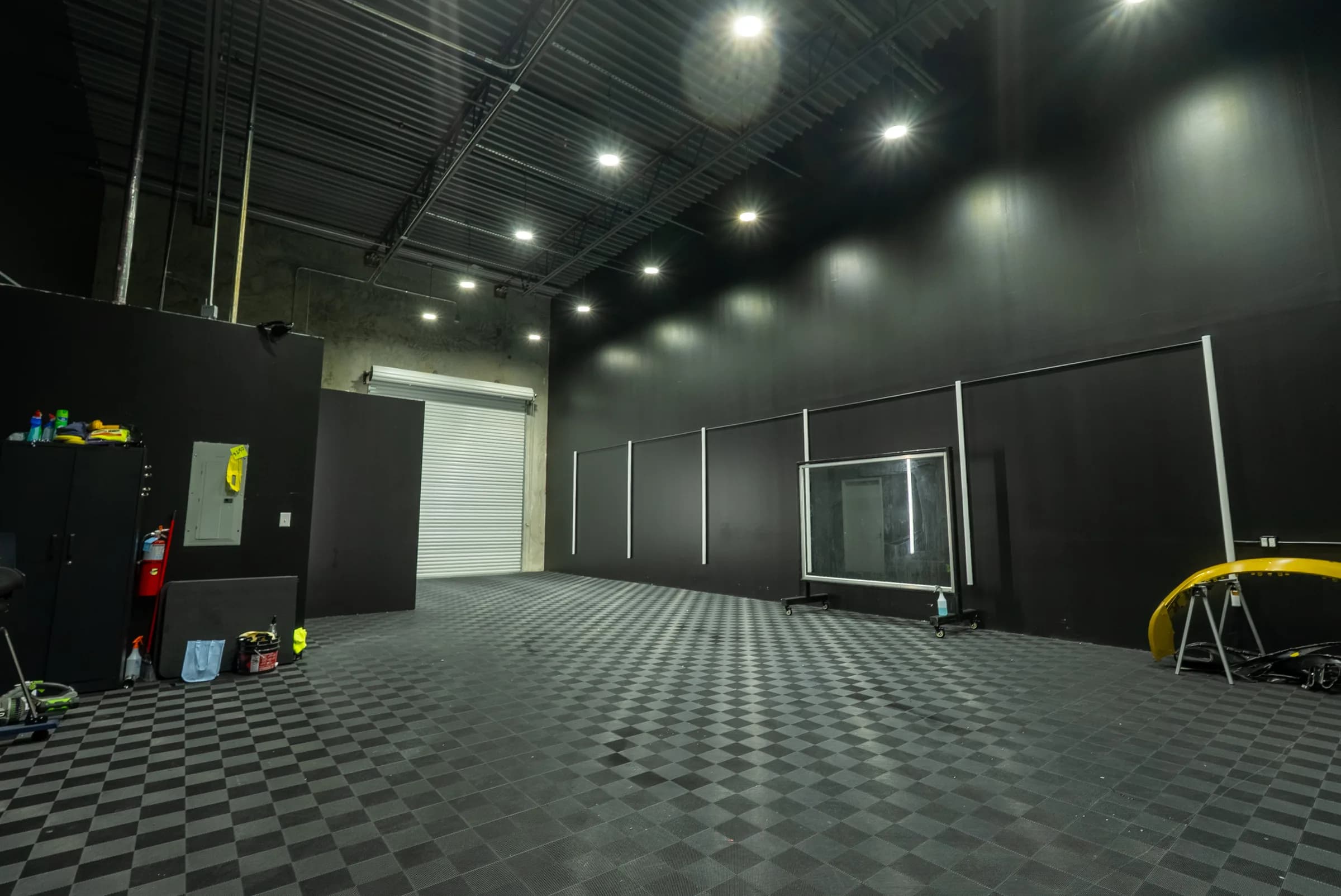 Wide view of the climate-controlled install bay with checkered flooring