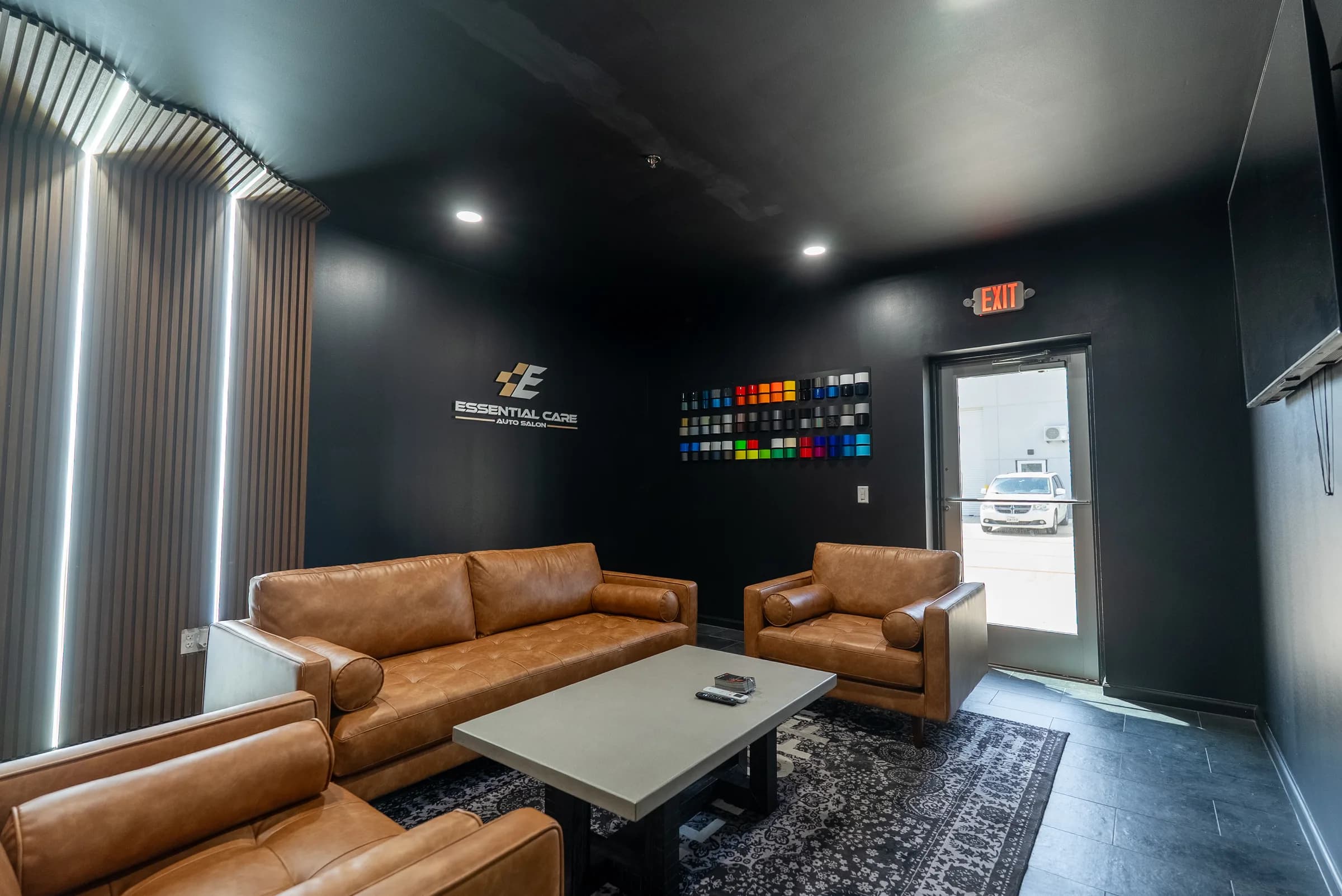 Client lounge seating with vinyl wrap and window film color samples on the wall near the entrance